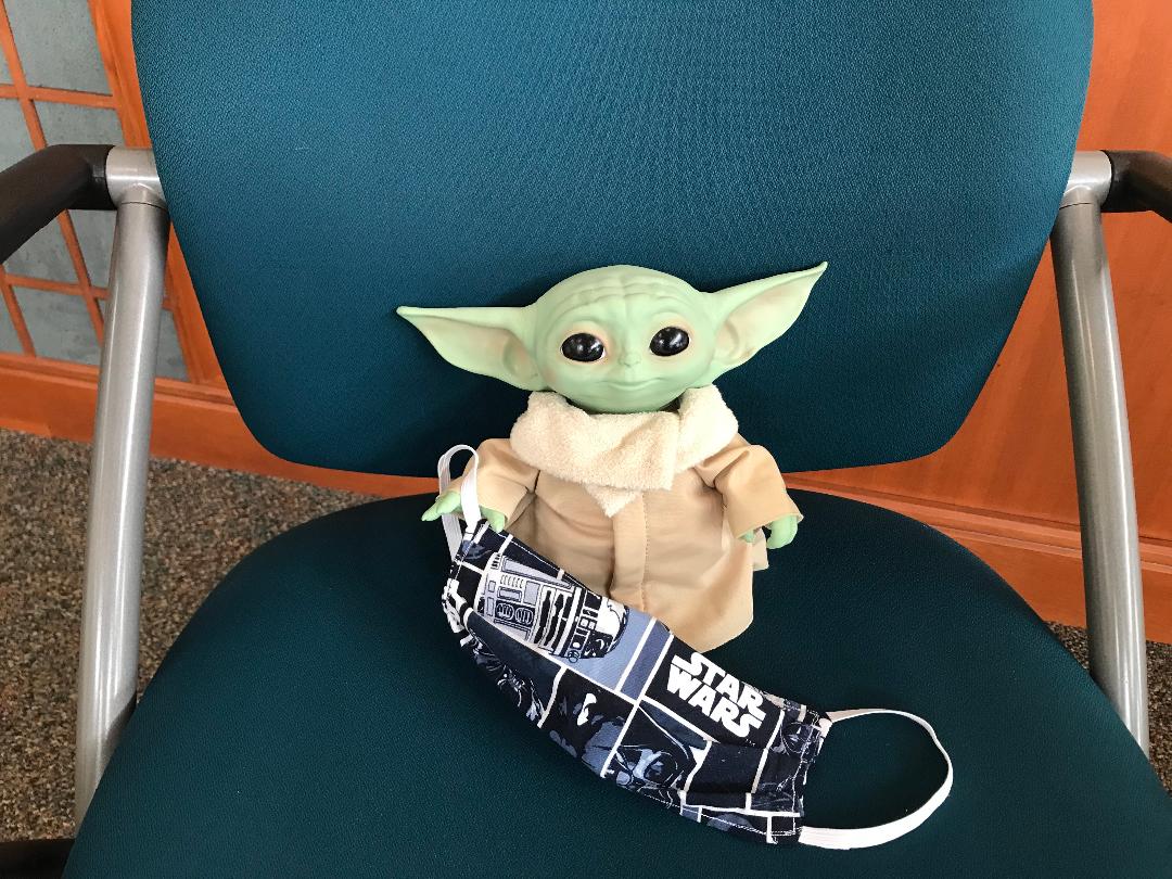 Baby Yoda Sitting on a Chair with Star Wars Mask