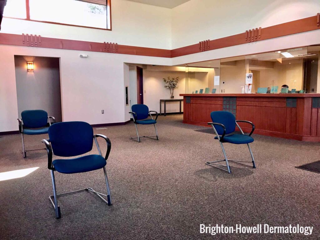 Four blue chairs in a lobby